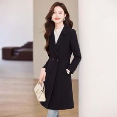 Black Suit Trench Coat Coat For Women Autumn, modeled by a woman, showcasing a stylish black trench coat in a modern setting.