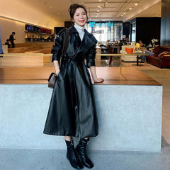 Autumn New Leather Trench Slim-fit Leather Coat worn by a model in black, stylishly posed in a modern interior.