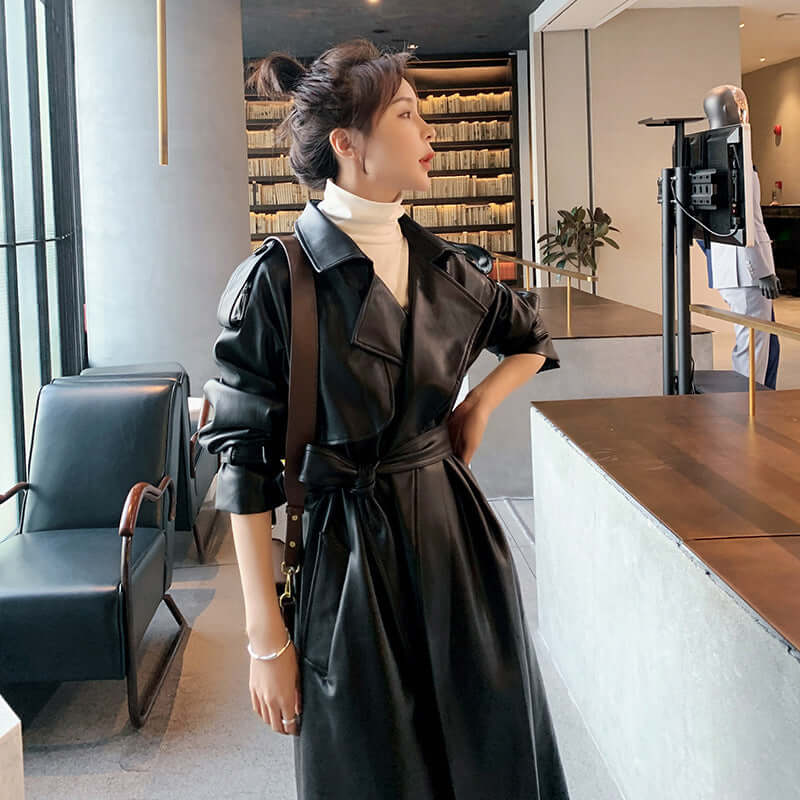 Autumn New Leather Trench Slim-fit Leather Coat worn by a woman in a modern indoor setting.