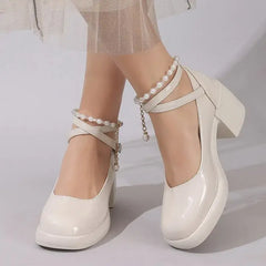 Elegant cross strap high heel pumps in white with pearl accents and a comfortable square heel.