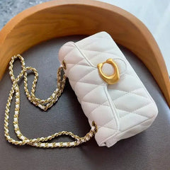 Luxury women's crossbody bag in white quilted leather with gold chain strap and decorative clasp.