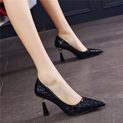 Black pointed toe pumps with thin heels on a woman, showcasing stylish office footwear, perfect for professional occasions.
