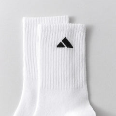 5 pairs of black and white patterned mid length socks suitable for both men and women comfortable and unisex sports socks